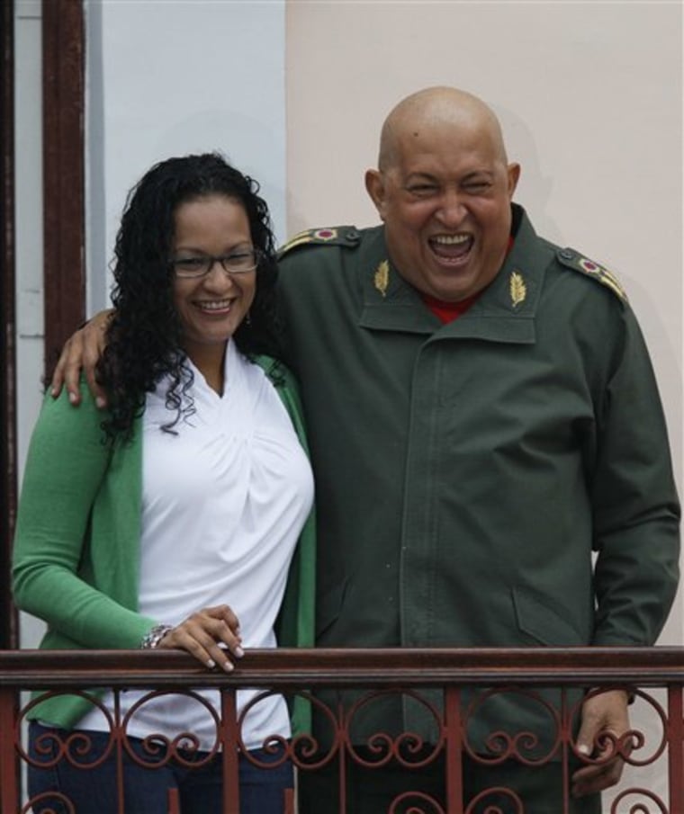 Venezuela's President Hugo Chavez, right, laughs Saturday while embracing his daughter, Rosa, on a balcony of the Miraflores presidential palace in Caracas, Venezuela.